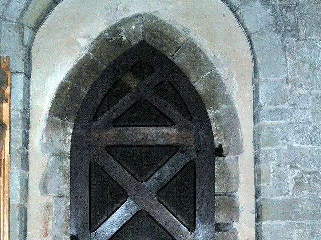 In this image there is a wooden door, in front of the door there is a flower bouquet.